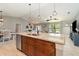 Modern kitchen with a large center island, pendant lighting, and an open view into the living area at 5125 Ariton Rd, North Port, FL 34288