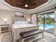 Main bedroom with a ceiling fan and sliding doors to the pool area at 5125 Ariton Rd, North Port, FL 34288