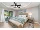 Comfortable main bedroom with sliding glass doors to the pool and a decorative tray ceiling at 5125 Ariton Rd, North Port, FL 34288