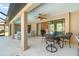Spacious covered patio with outdoor seating and a ceiling fan at 5125 Ariton Rd, North Port, FL 34288