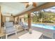 Covered patio with comfortable seating and a ceiling fan overlooking the pool at 5125 Ariton Rd, North Port, FL 34288