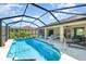 Enjoy the lanai's refreshing pool in this home with a screened enclosure, perfect for relaxation and entertaining at 5125 Ariton Rd, North Port, FL 34288