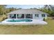 Back of home, view of the pool, patio, and waterfront at 535 Ramblewood St, Port Charlotte, FL 33953