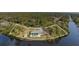 Aerial view of waterfront home with lush landscaping and access to canal at 535 Ramblewood St, Port Charlotte, FL 33953