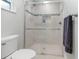 Bright bathroom featuring a glass shower with tile accents and a neutral color scheme at 535 Ramblewood St, Port Charlotte, FL 33953
