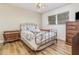 Well-lit bedroom featuring hardwood floors, ceiling fan, and vintage furniture at 535 Ramblewood St, Port Charlotte, FL 33953
