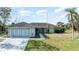 Charming single-story home featuring a spacious three-car garage and well-manicured lawn at 535 Ramblewood St, Port Charlotte, FL 33953