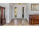 Bright foyer featuring hardwood floors, closet space, and sidelight windows framing the door at 535 Ramblewood St, Port Charlotte, FL 33953