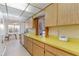 Functional kitchen featuring ample cabinetry and a breakfast bar with a pass-through window at 535 Ramblewood St, Port Charlotte, FL 33953