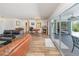 Open concept living room featuring laminate floors, fireplace and walls of sliding glass doors at 535 Ramblewood St, Port Charlotte, FL 33953