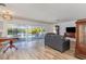 Bright living room with laminate floors and views of outdoor pool and patio area at 535 Ramblewood St, Port Charlotte, FL 33953