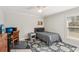 This bedroom has a single bed, gray and black area rug and a window with blinds at 5805 Casanova Ave, North Port, FL 34291