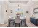 This formal dining area features modern lighting, and a large window that offers natural light at 5805 Casanova Ave, North Port, FL 34291