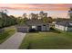 Beautiful single-Gathering home with a lush green lawn and a charming two-car garage at 5805 Casanova Ave, North Port, FL 34291