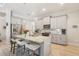Bright kitchen featuring an island, stainless appliances, light gray cabinets, and pendant lighting at 5805 Casanova Ave, North Port, FL 34291