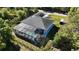 Aerial view of home, driveway, surrounding landscape and screened in pool area at 7344 Manthey Ave, North Port, FL 34291