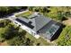 Aerial view of home exterior showing solar panels, screened pool, tank and equipment at 7344 Manthey Ave, North Port, FL 34291