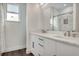 Modern bathroom features double sink vanity, large mirror, and glass enclosed shower with marble tile at 7344 Manthey Ave, North Port, FL 34291