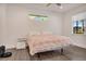 Cozy bedroom featuring wood floors, large windows, and a comfortable bed with a stylish comforter at 7344 Manthey Ave, North Port, FL 34291