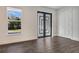 Entryway with black framed door and wood-look flooring at 7344 Manthey Ave, North Port, FL 34291