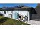 Back side of home exterior with visible water tank, solar panels, and partial view of the screened in pool at 7344 Manthey Ave, North Port, FL 34291