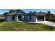 Charming single-story home featuring a modern garage door, solar panels, and a well-manicured lawn at 7344 Manthey Ave, North Port, FL 34291