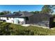 Exterior angle of back yard showing screened in pool, house, solar panels, and green grass at 7344 Manthey Ave, North Port, FL 34291