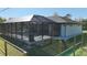 Exterior angle of screened in pool and back yard with a partial view of the home at 7344 Manthey Ave, North Port, FL 34291