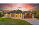 Beautiful exterior shot of home, featuring modern garage door, solar panels and appealing landscaping at 7344 Manthey Ave, North Port, FL 34291
