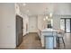 Modern kitchen with stainless steel appliances, sleek white cabinetry and an island with barstool seating at 7344 Manthey Ave, North Port, FL 34291