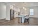 A bright kitchen has modern appliances and a long center island with bar stool seating at 7344 Manthey Ave, North Port, FL 34291
