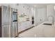 Gourmet kitchen features stainless steel appliances, sleek white cabinetry and large marble countertop space at 7344 Manthey Ave, North Port, FL 34291