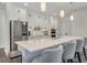 Modern kitchen with white cabinets, stainless appliances, marble backsplash, and a large center island at 7344 Manthey Ave, North Port, FL 34291