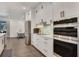 Modern kitchen with stainless steel appliances, sleek white cabinetry and a large center island at 7344 Manthey Ave, North Port, FL 34291