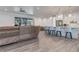 Open concept living room features a comfortable seating area, barstool seating, and plenty of natural light at 7344 Manthey Ave, North Port, FL 34291