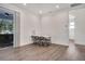 Bright living room with wood floors features a sliding glass door and access to other rooms at 7344 Manthey Ave, North Port, FL 34291