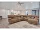 Spacious living room with lots of natural light, modern ceiling fan, and open floor plan at 7344 Manthey Ave, North Port, FL 34291
