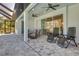 Relaxing screened patio with comfortable seating, ceiling fans, and a beautiful tile floor at 7344 Manthey Ave, North Port, FL 34291
