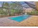 Screened pool area featuring a pool and hot tub with brick pavers and a lush outdoor view at 7344 Manthey Ave, North Port, FL 34291