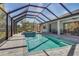 Beautiful in-ground pool and hot tub under screened enclosure with ample deck space at 7344 Manthey Ave, North Port, FL 34291