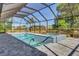 Beautiful pool and hot tub under a screened enclosure with ample deck space and outdoor grill at 7344 Manthey Ave, North Port, FL 34291