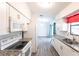 Modern kitchen seamlessly connects to a dining area and showcases granite countertops and stainless steel appliances at 963 Kennwood Nw Ter, Port Charlotte, FL 33948