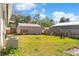 View of backyard featuring green grass, storage sheds and partial fencing at 102 21St Ne St, Bradenton, FL 34208