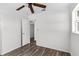 This bedroom features wood-look floors, a ceiling fan, and neutral walls at 102 21St Ne St, Bradenton, FL 34208