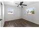 This bedroom has wood-look floors, a ceiling fan and a large window for natural light at 102 21St Ne St, Bradenton, FL 34208