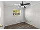 This bedroom features one window, wood-look floors, and a ceiling fan at 102 21St Ne St, Bradenton, FL 34208