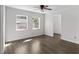 Bright bedroom with two windows, wood-look floors, and access to an additional room at 102 21St Ne St, Bradenton, FL 34208