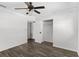 This bedroom has neutral walls, wood-look floors, a closet and a ceiling fan at 102 21St Ne St, Bradenton, FL 34208