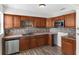 Well-lit kitchen with wooden cabinets, stainless steel dishwasher, and modern microwave at 102 21St Ne St, Bradenton, FL 34208