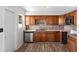 Charming kitchen with wood cabinets, mosaic backsplash, and stainless steel appliances at 102 21St Ne St, Bradenton, FL 34208